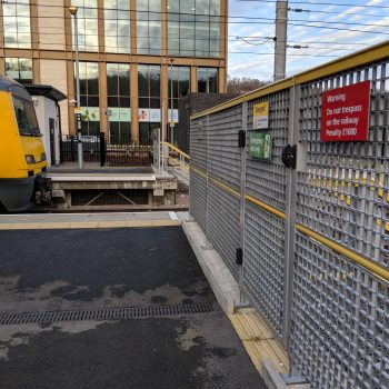 Grated Gate and Railway Fence at a Train Station